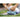 Person stretching neck using foam roller outdoors on yoga mat in a grassy area