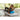 Woman exercises with foam roller on mat near window in bright room.