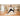 Yoga mat supports woman practicing yoga in spacious room with large windows and plants.
