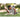 Man exercises outdoors using a foam roller on the grass in a garden setting.