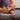 Person adjusts a fitness tracker on their ankle in a fitness setting with a focus on customizable fit.